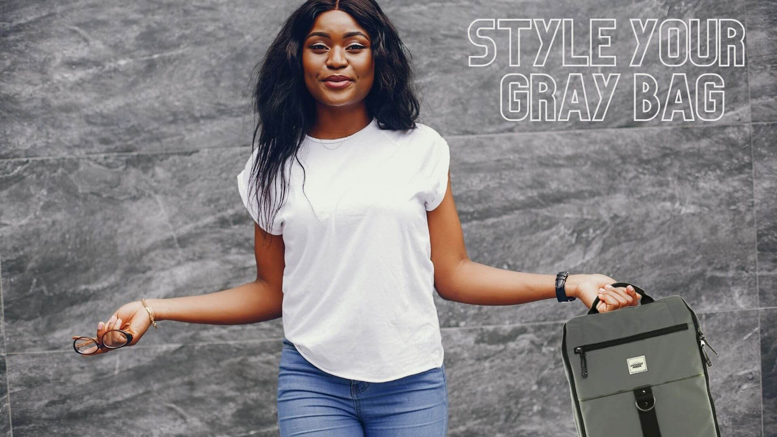 A girl standing awkwardly and holding the gray Anvanda Great Fucking Bag