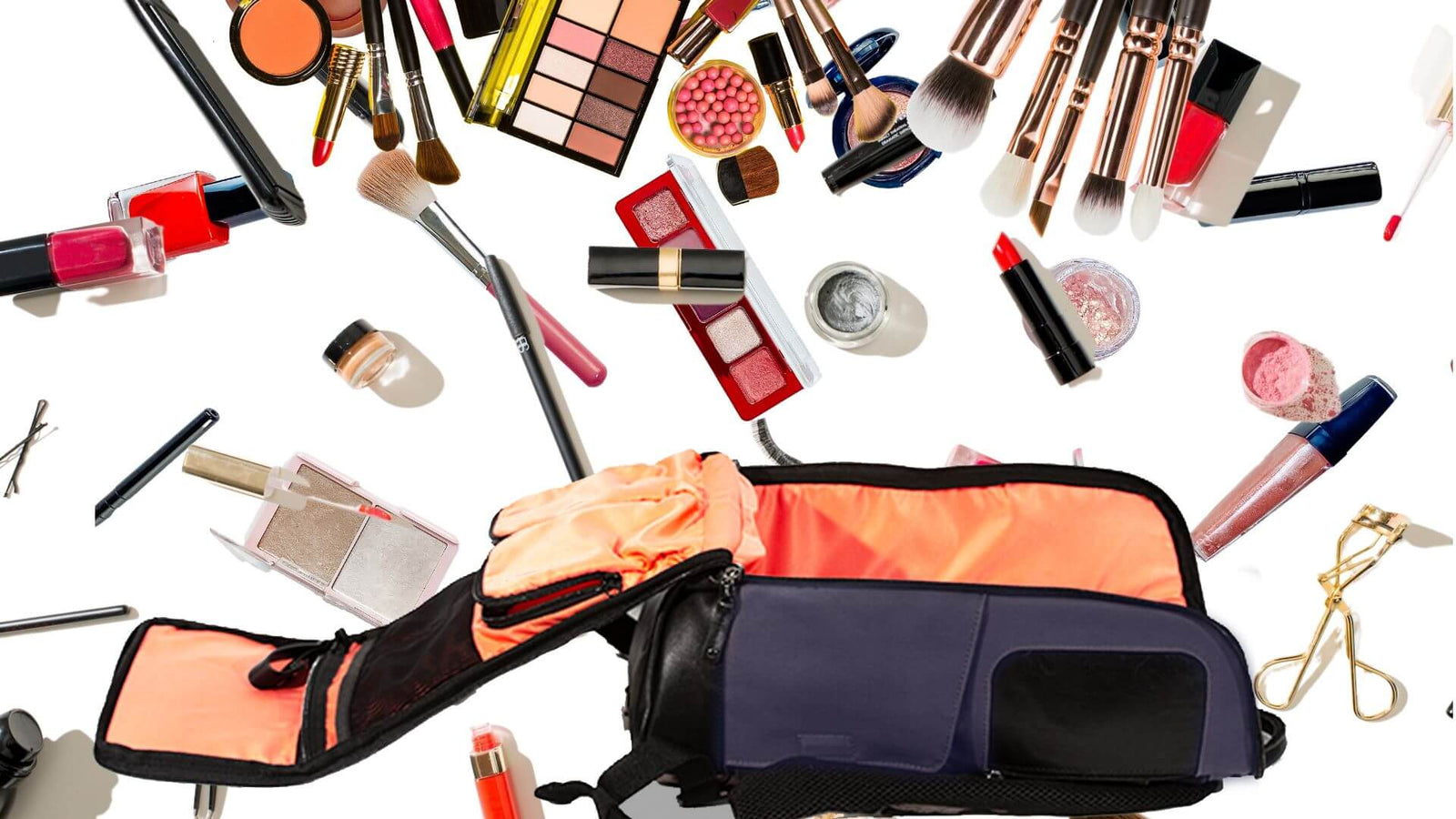 A bunch of makeup scattered around a bag